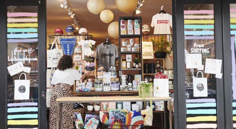 An employee adjusts face masks displayed for sale in an open window for curbside pickup at a Lockwood store in the Astoria neighborhood in the Queens borough of New York, U.S., on Friday, June 5, 2020. For New York's small businesses, which depend almost entirely on city residents, Monday marked a vital moment to start bringing in the customers and revenue they lost during the shutdown  an undertaking all the more precarious with the current social unrest. Photographer: Gabby Jones/Bloomberg via Getty Images